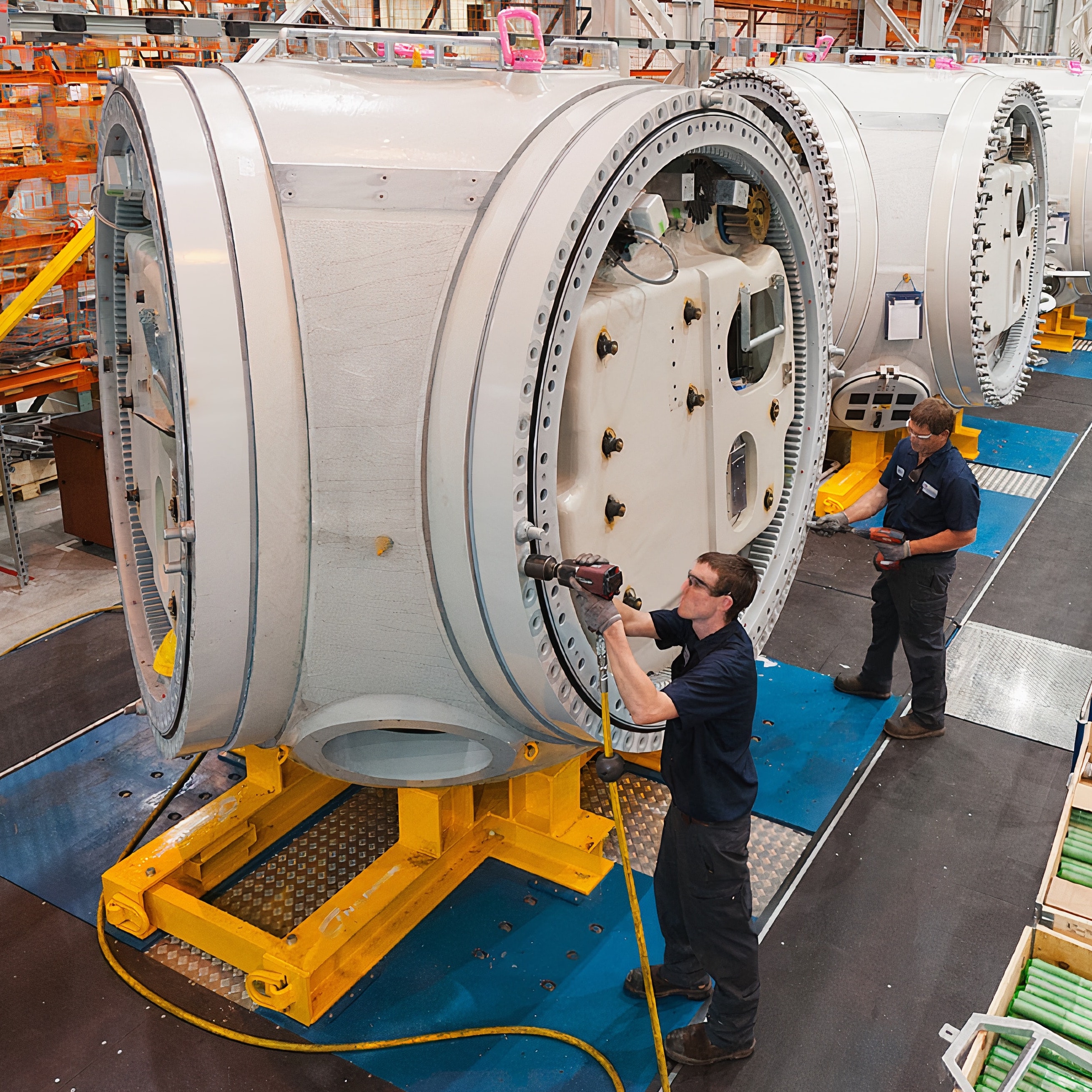 Two men working on a large engine